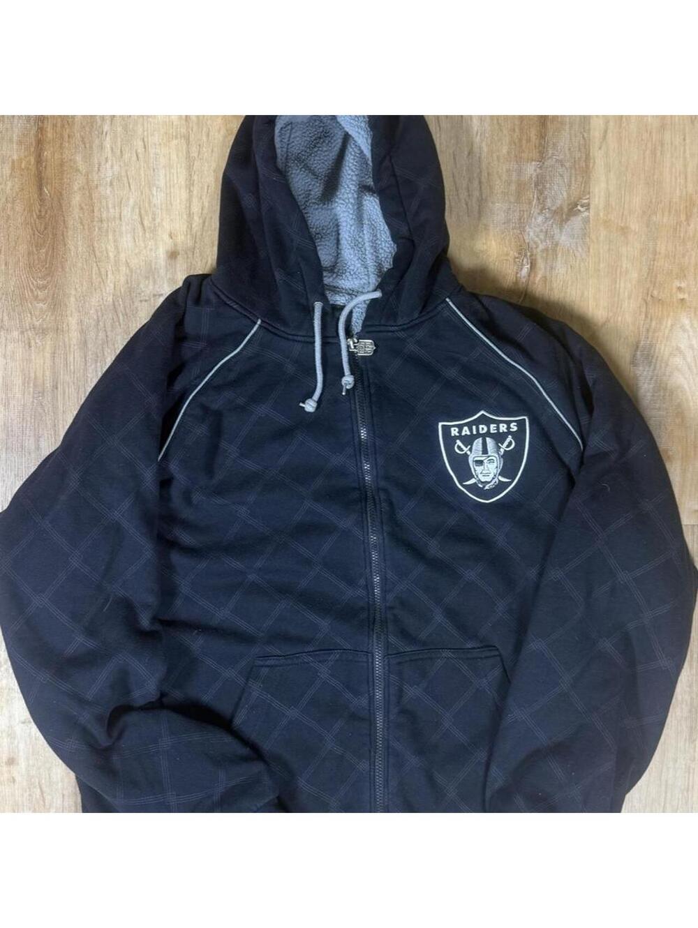 90s NFL Raiders black zip-up hoodie with subtle grey design.